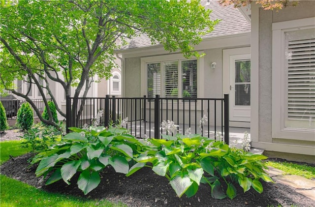 6306 W 128th St, Overland Park, KS 66209 - doorway to property featuring stucco siding and a shingled roof