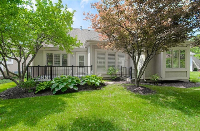 6306 W 128th St, Overland Park, KS 66209 - back of property with stucco siding, a yard, and a shingled roof