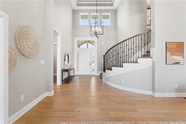 15837 El Monte St, Overland Park, KS 66224 - entryway with a chandelier, wood finished floors, stairway, and a towering ceiling