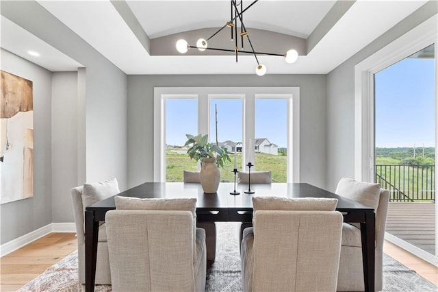 15837 El Monte St, Overland Park, KS 66224 - dining area with a chandelier, light wood-type flooring, healthy amount of natural light, and vaulted ceiling