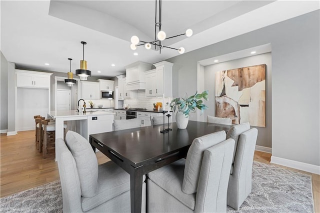 15837 El Monte St, Overland Park, KS 66224 - dining space with light wood-style flooring, a chandelier, and recessed lighting