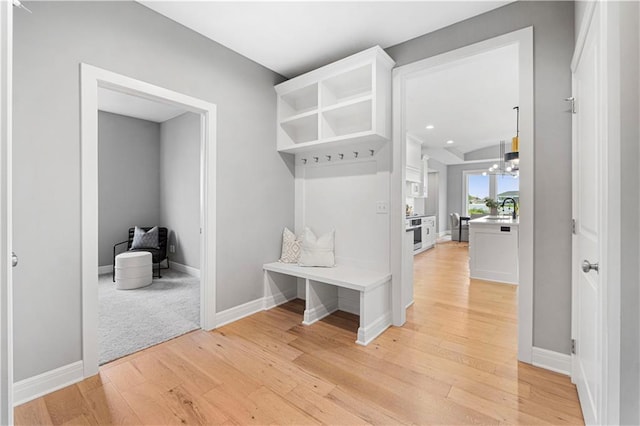 15837 El Monte St, Overland Park, KS 66224 - mudroom featuring light wood-type flooring and a chandelier