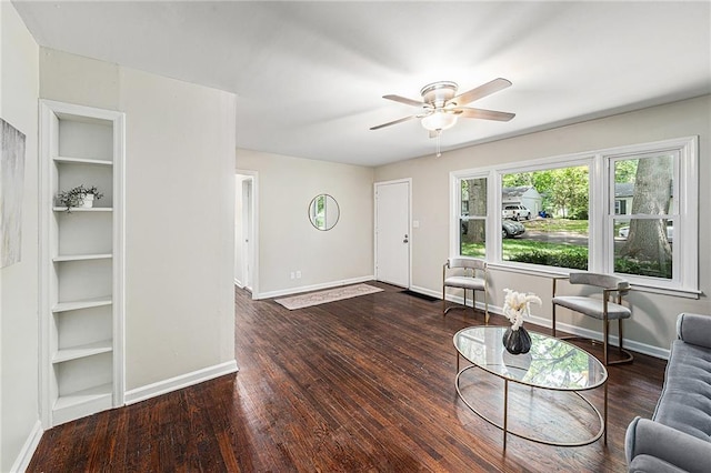 9023 E 74th Ter, Raytown, MO 64133 - living room featuring ceiling fan, built in features, and wood finished floors