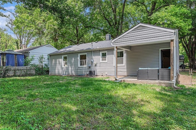 9023 E 74th Ter, Raytown, MO 64133 - back of house with outdoor lounge area, a chimney, and a patio