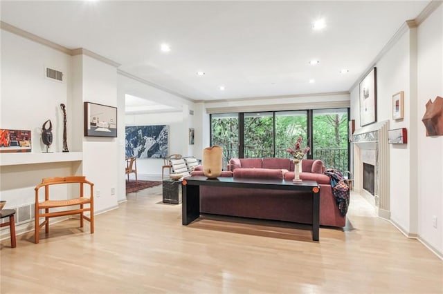 433 Ward Pkwy Unit 1S, Kansas City, MO 64112 - living area featuring ornamental molding, light wood finished floors, recessed lighting, and a high end fireplace