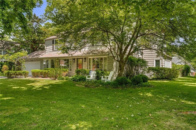 6451 Sagamore Rd, Mission Hills, KS 66208 - view of front facade featuring a front lawn, an attached garage, and covered porch