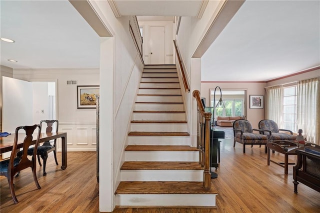 6451 Sagamore Rd, Mission Hills, KS 66208 - staircase with wood finished floors, ornamental molding, and recessed lighting