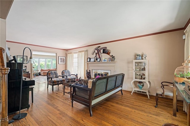 6451 Sagamore Rd, Mission Hills, KS 66208 - living room featuring a glass covered fireplace, wood finished floors, and ornamental molding