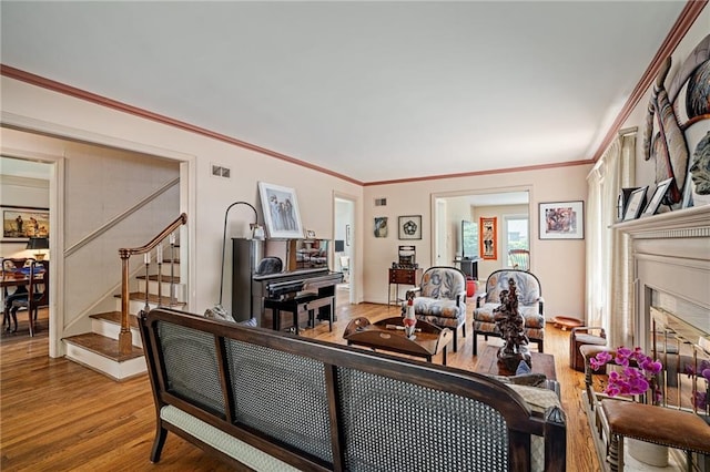 6451 Sagamore Rd, Mission Hills, KS 66208 - living area with stairs, wood finished floors, a glass covered fireplace, and crown molding