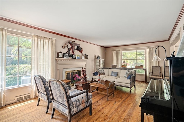 6451 Sagamore Rd, Mission Hills, KS 66208 - living area with light wood-type flooring, ornamental molding, and a glass covered fireplace