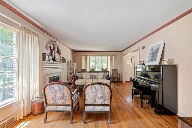 6451 Sagamore Rd, Mission Hills, KS 66208 - living room featuring ornamental molding, light wood-style flooring, and a glass covered fireplace