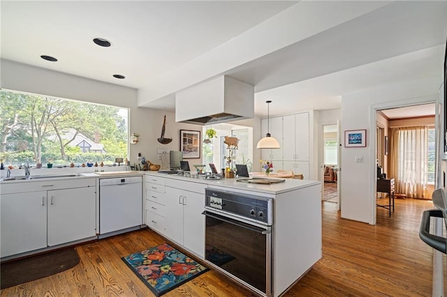 6451 Sagamore Rd, Mission Hills, KS 66208 - kitchen with white dishwasher, dark wood-style floors, a peninsula, light countertops, and plenty of natural light