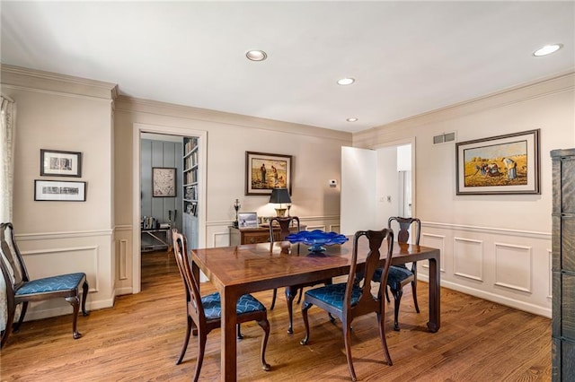 6451 Sagamore Rd, Mission Hills, KS 66208 - dining space with ornamental molding, a decorative wall, light wood-type flooring, recessed lighting, and wainscoting