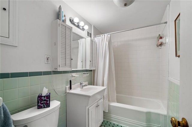 6451 Sagamore Rd, Mission Hills, KS 66208 - bathroom featuring vanity, shower / bath combo with shower curtain, and tile walls