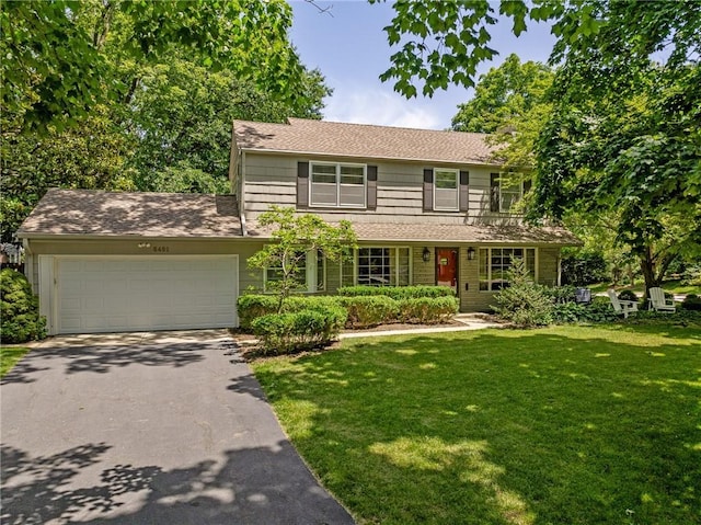 6451 Sagamore Rd, Mission Hills, KS 66208 - view of front of property featuring asphalt driveway, a front yard, a garage, and a shingled roof