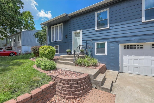 16100 E Elm St, Independence, MO 64050 - view of exterior entry featuring a lawn and an attached garage