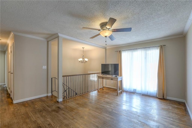 16100 E Elm St, Independence, MO 64050 - unfurnished living room with a chandelier, wood finished floors, a textured ceiling, crown molding, and ceiling fan