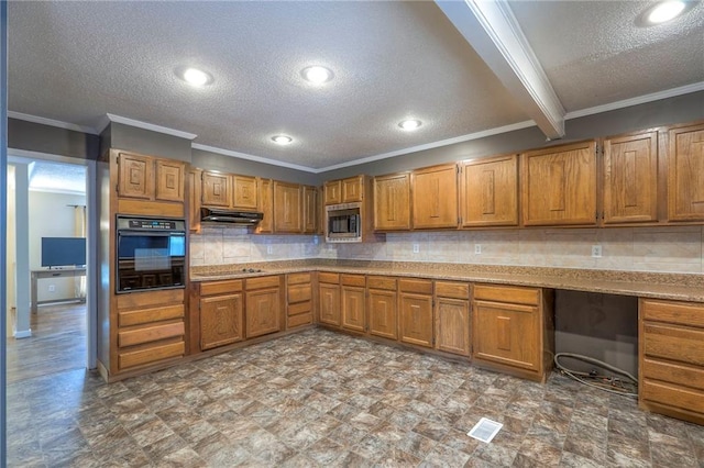 16100 E Elm St, Independence, MO 64050 - kitchen with black appliances, under cabinet range hood, ornamental molding, brown cabinets, and a textured ceiling