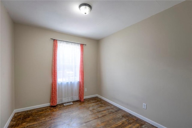 16100 E Elm St, Independence, MO 64050 - empty room featuring dark wood-type flooring and baseboards