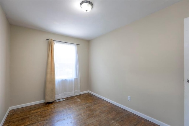 16100 E Elm St, Independence, MO 64050 - empty room featuring baseboards and wood finished floors