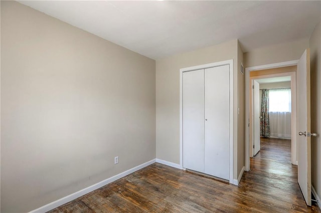 16100 E Elm St, Independence, MO 64050 - unfurnished bedroom featuring dark wood finished floors and a closet