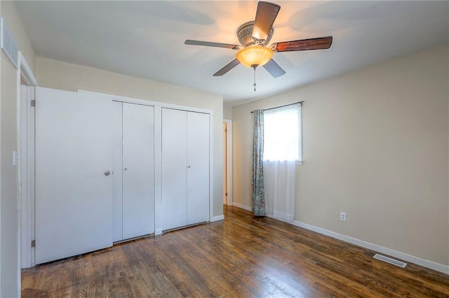 16100 E Elm St, Independence, MO 64050 - unfurnished bedroom featuring two closets, wood finished floors, and ceiling fan