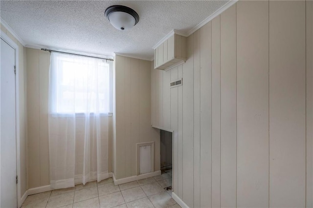16100 E Elm St, Independence, MO 64050 - laundry area featuring a textured ceiling, ornamental molding, and light tile patterned flooring
