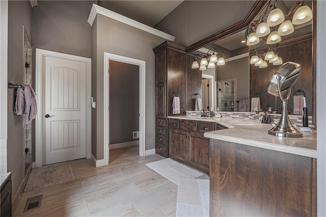 1217 Kingsland Cir, Raymore, MO 64083 - bathroom with vanity, a chandelier, and ornamental molding