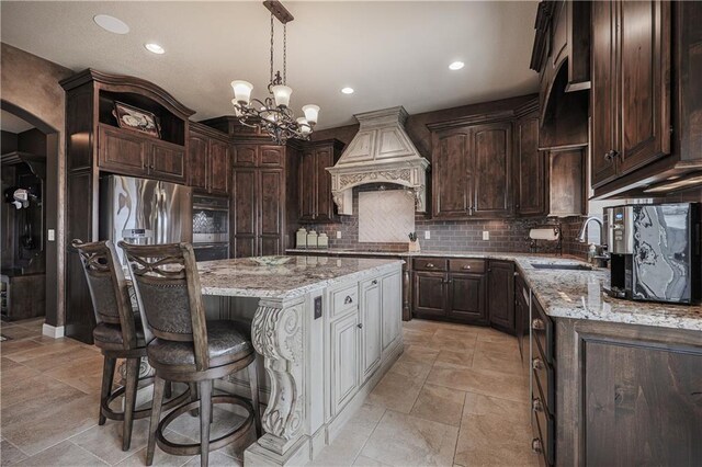 1217 Kingsland Cir, Raymore, MO 64083 - kitchen with custom exhaust hood, open shelves, dark brown cabinetry, and recessed lighting