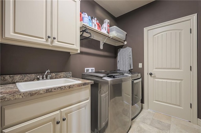 1217 Kingsland Cir, Raymore, MO 64083 - laundry room with washer and clothes dryer, cabinet space, and light stone finish floors