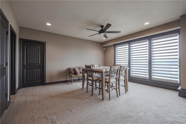 1217 Kingsland Cir, Raymore, MO 64083 - dining room with light colored carpet, ceiling fan, a textured ceiling, and recessed lighting