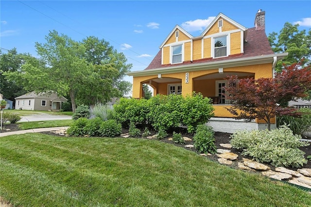 533 S Water St, Olathe, KS 66061 - view of front of home featuring a chimney, a front yard, stucco siding, and a porch
