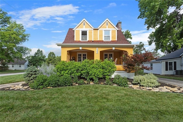 533 S Water St, Olathe, KS 66061 - view of front of property with a chimney, a front lawn, stucco siding, and covered porch