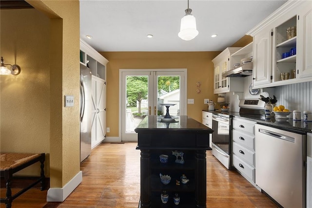 533 S Water St, Olathe, KS 66061 - kitchen with open shelves, appliances with stainless steel finishes, dark countertops, white cabinets, and a center island