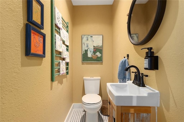 533 S Water St, Olathe, KS 66061 - bathroom featuring a textured wall, tile patterned floors, and vanity