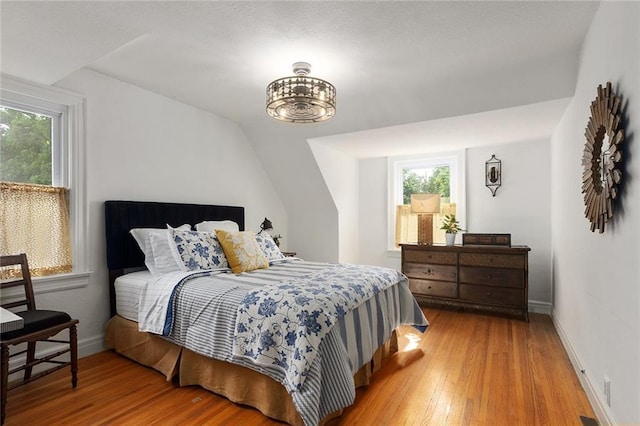 533 S Water St, Olathe, KS 66061 - bedroom featuring multiple windows, light wood-style floors, and vaulted ceiling