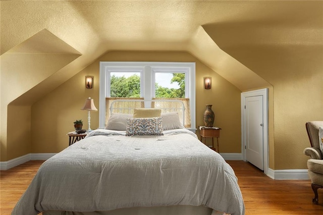 533 S Water St, Olathe, KS 66061 - bedroom with vaulted ceiling, wood finished floors, and a textured ceiling