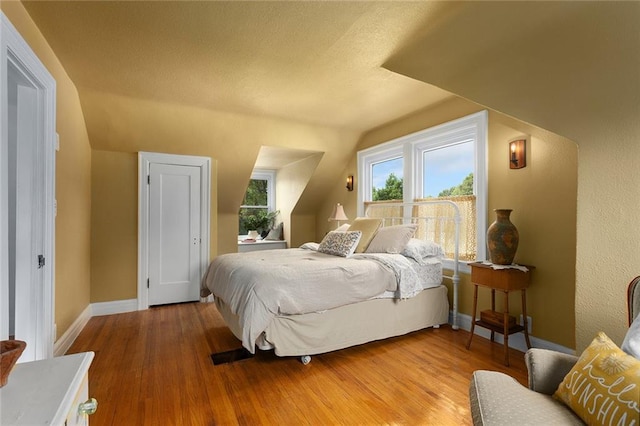 533 S Water St, Olathe, KS 66061 - bedroom with lofted ceiling, wood finished floors, and a textured ceiling