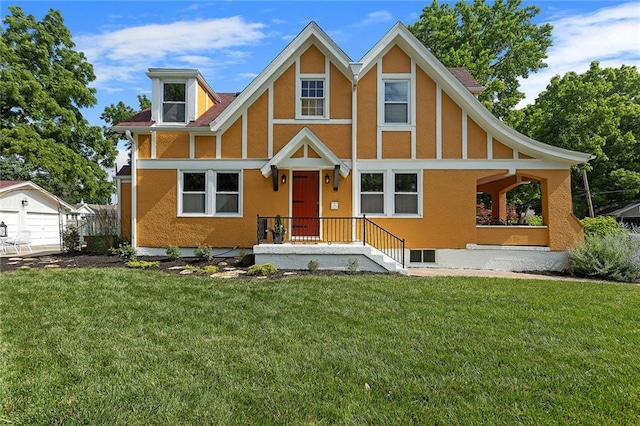 533 S Water St, Olathe, KS 66061 - tudor home with a front yard, stucco siding, and a detached garage