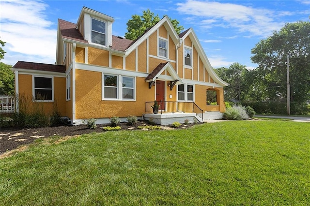 533 S Water St, Olathe, KS 66061 - tudor house featuring stucco siding, a front lawn, and roof with shingles