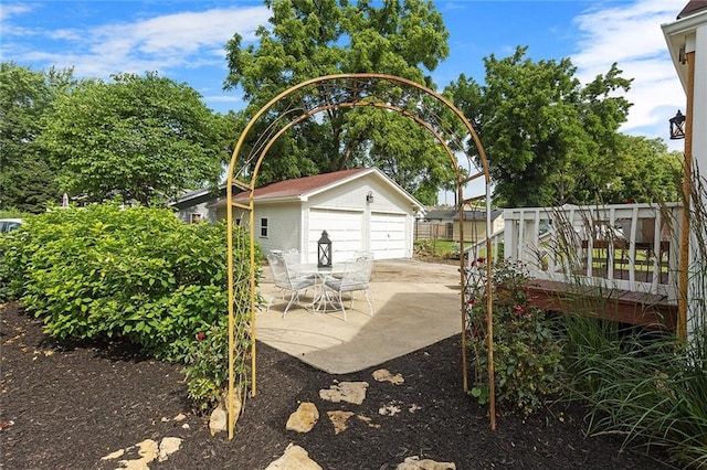 533 S Water St, Olathe, KS 66061 - view of yard featuring a detached garage, an outbuilding, and a wooden deck