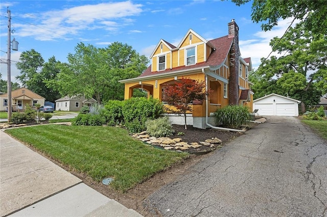 533 S Water St, Olathe, KS 66061 - view of front of house with an outdoor structure, a garage, a porch, a chimney, and a front yard