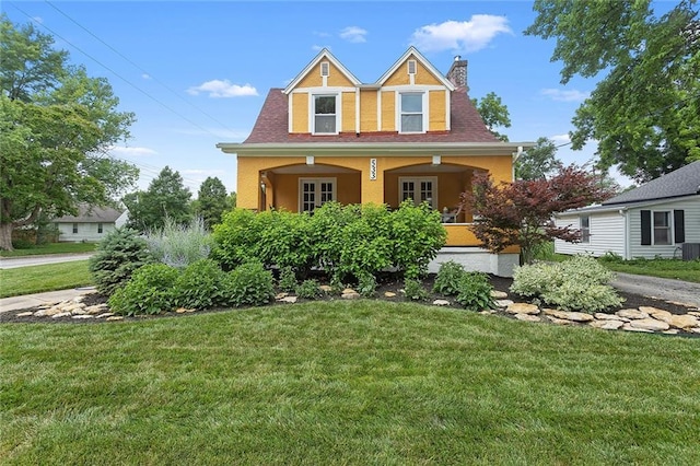 533 S Water St, Olathe, KS 66061 - view of front of house featuring a front lawn, a chimney, french doors, and stucco siding