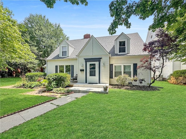 1607 S St, Lexington, MO 64067 - cape cod home featuring a front yard, roof with shingles, and a chimney