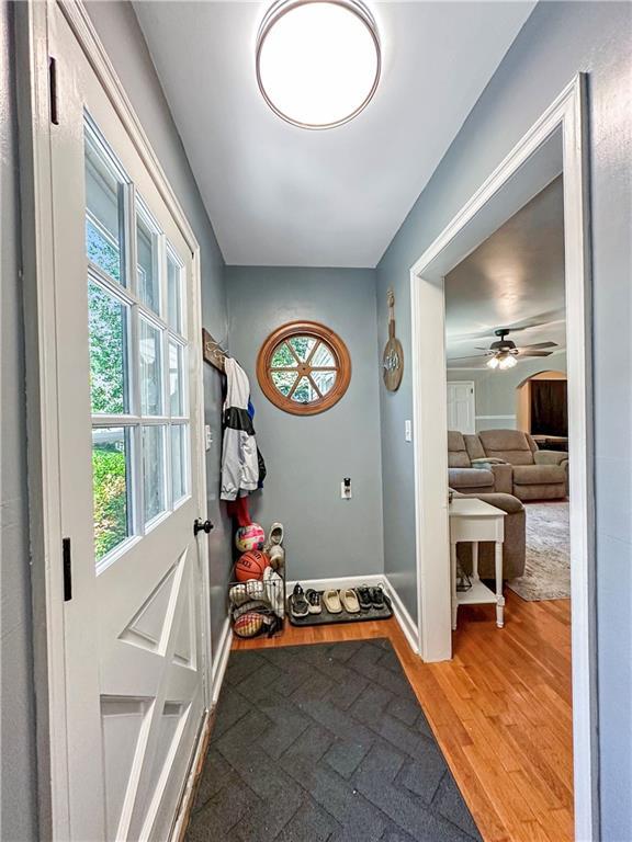 1607 S St, Lexington, MO 64067 - doorway featuring light wood finished floors and a ceiling fan