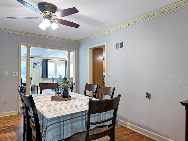 1607 S St, Lexington, MO 64067 - dining area with wood finished floors, decorative columns, crown molding, and a ceiling fan