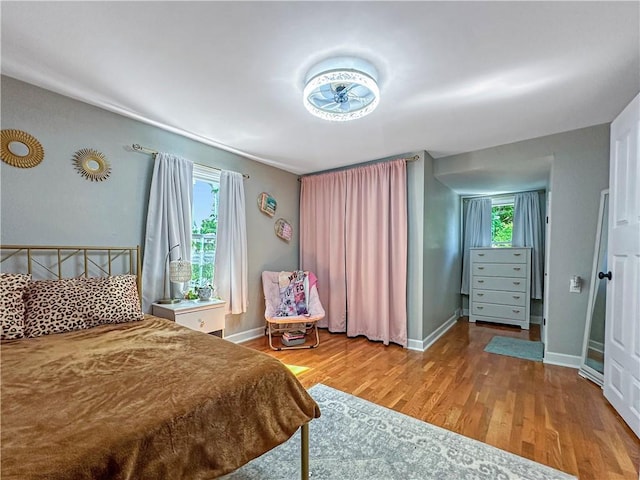 1607 S St, Lexington, MO 64067 - bedroom with wood finished floors and multiple windows