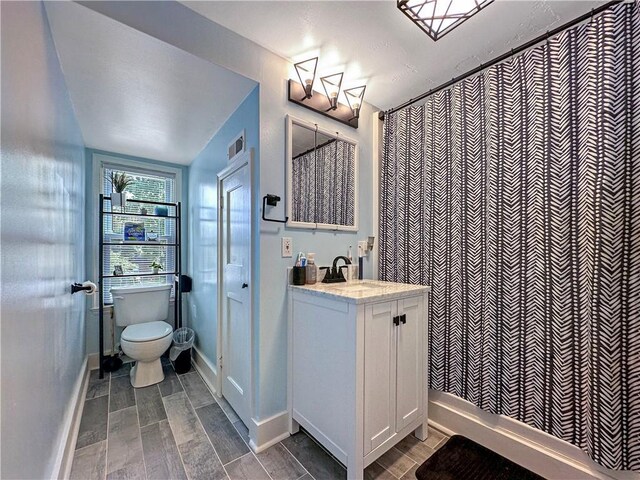 1607 S St, Lexington, MO 64067 - full bath with vanity, wood finished floors, and a shower with shower curtain