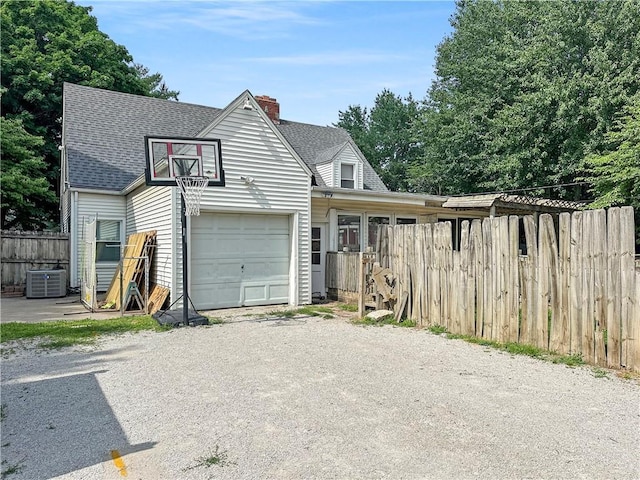 1607 S St, Lexington, MO 64067 - traditional home with roof with shingles, a chimney, and gravel driveway