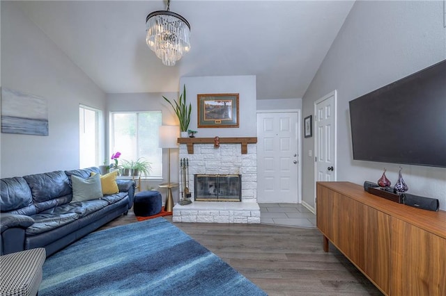 13148 S Brougham Dr, Olathe, KS 66062 - living room with vaulted ceiling, a chandelier, wood finished floors, and a fireplace